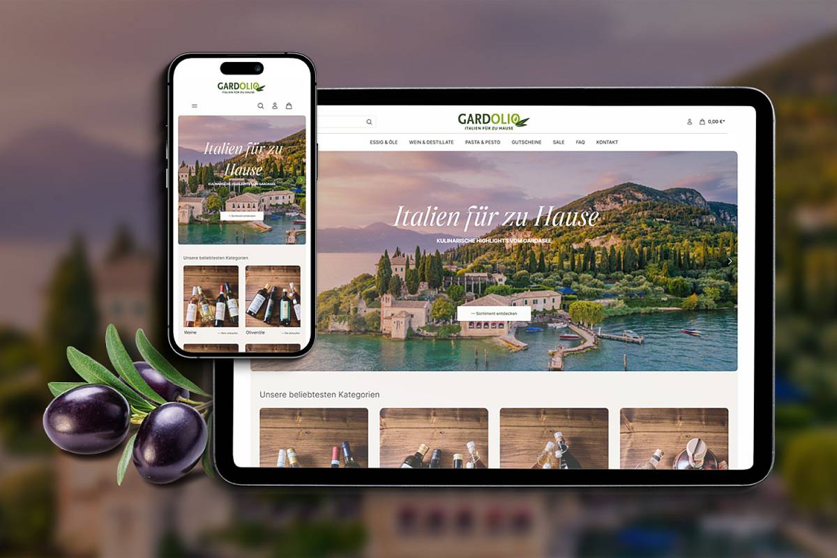 Smartphone und Tablet mit geöffnetem Onlineshop für italienische Feinkost vor einer Landschaft am Gardasee.